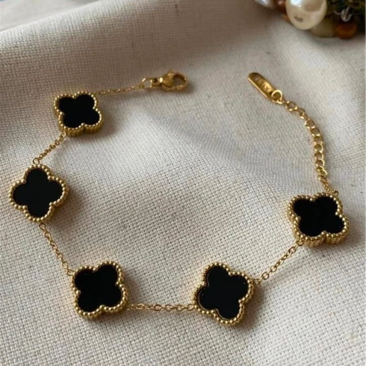 Intricate black flower bracelet with detailed petals, modern gothic jewelry style.