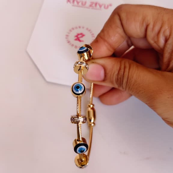 Modern eye design bracelet with centered iris detail and gold-tone finish.