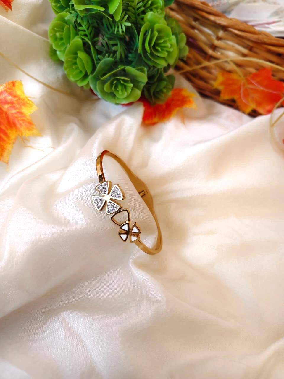 Polished gold bracelet with a modern minimalist design, captured in natural lighting.